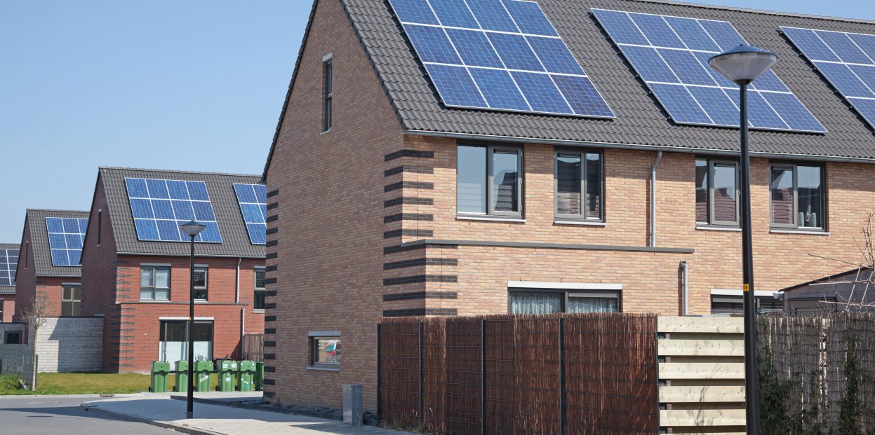 An image of multiple houses fitted with solar panels on the roof
